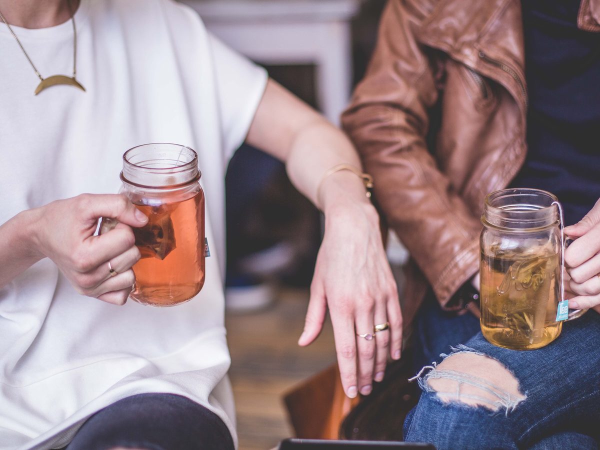Friends talking together over tea
