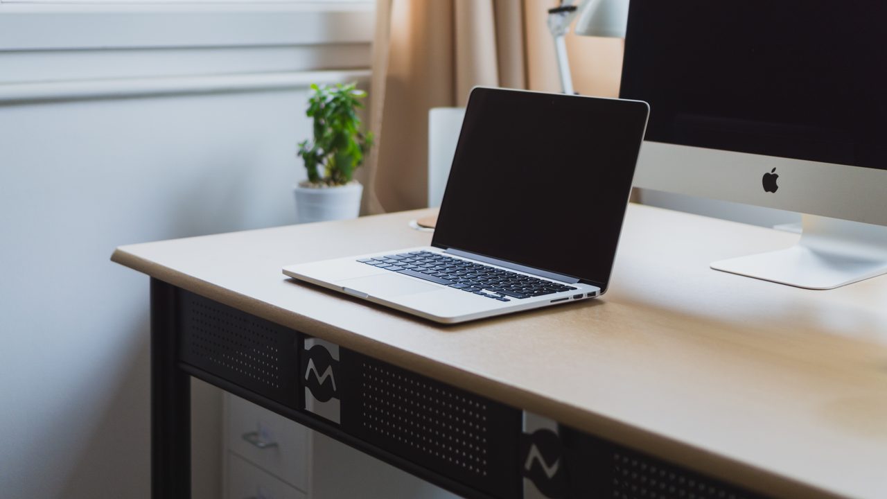 A laptop open on a tidy desk